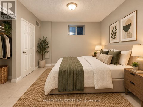 A bedroom with a bed, nightstand, and a window.