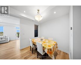 A dining room with a table set for four.