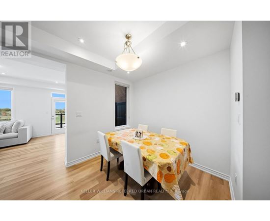 A dining room with a table set for four.