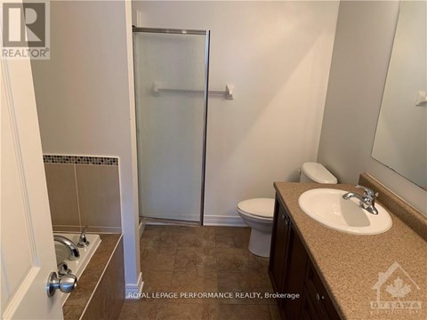 A bathroom with a toilet, sink, and shower.