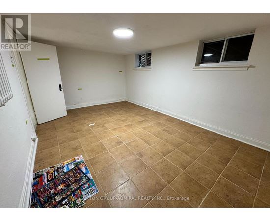 A room with a tiled floor and a window with a white frame.