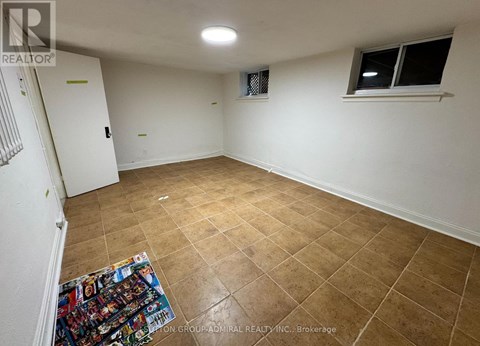 A room with a tiled floor and a window with a white frame.