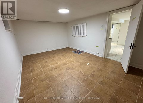 A room with a tiled floor and a radiator on the wall.