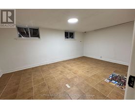 A room with tiled flooring and two windows.