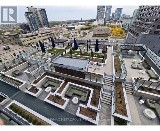 A rooftop garden with a pool and lounge chairs overlooks a cityscape.