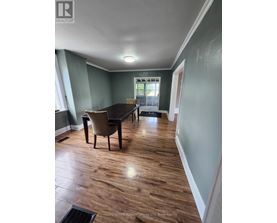 A room with a table and chairs in it.