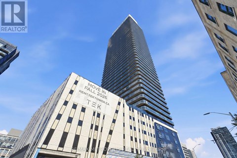 A tall building with a sign that says "TEK" on it.