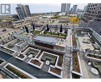 A rooftop garden with a pool and lounge chairs overlooks a cityscape.