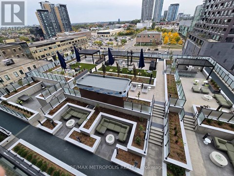 A rooftop garden with a pool and lounge chairs overlooks a cityscape.