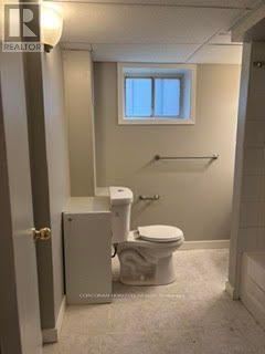 A small bathroom with a toilet and a bidet.