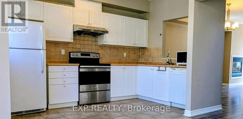 A kitchen with white cabinets and a stainless steel dishwasher.