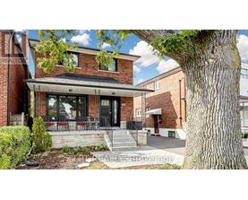 A brick house with a black door and windows.