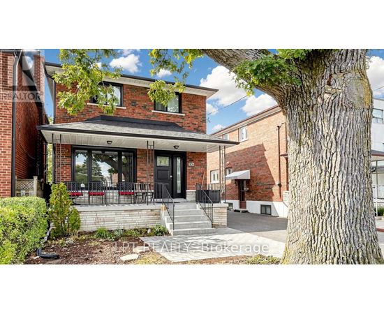 A brick house with a black door and windows.