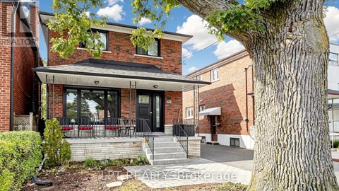 A brick house with a black door and windows.