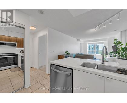 A modern kitchen with white cabinets and stainless steel appliances.