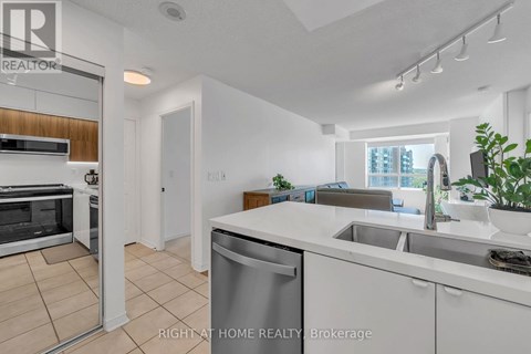A modern kitchen with white cabinets and stainless steel appliances.