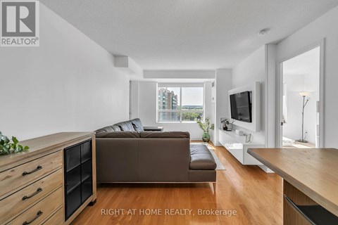 A modern living room with a brown sofa and a television.