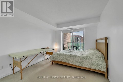 A bedroom with a bed, desk, and chair.
