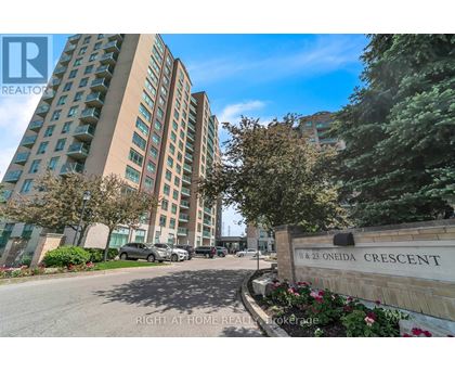 A tall building with the name Oneida Crescent on a sign in front of it.