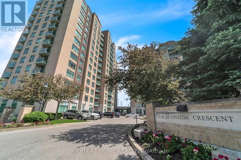 A tall building with the name Oneida Crescent on a sign in front of it.