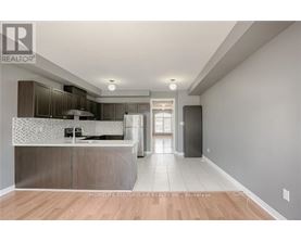 A modern kitchen with a wooden floor and a large island.