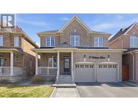 A house with a brick facade and a garage is for sale.