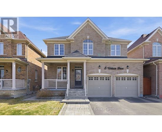A house with a brick facade and a garage is for sale.