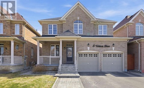 A house with a brick facade and a garage is for sale.