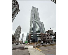 A tall building with many windows is under construction in a city.