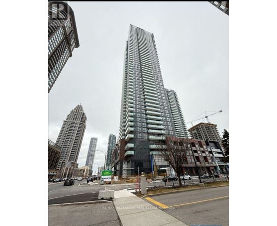 A tall building with many windows is under construction in a city.