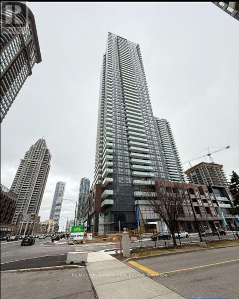 A tall building with many windows is under construction in a city.