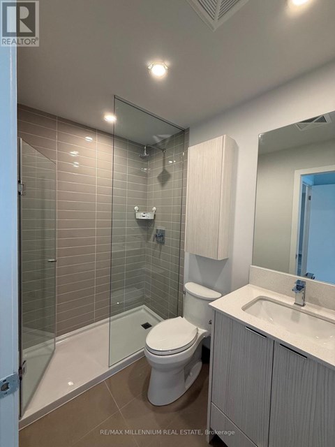A bathroom with a toilet, sink, and shower.