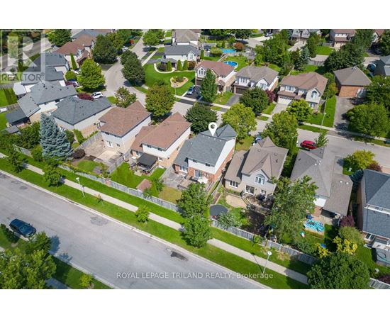 A bird's eye view of a residential neighborhood with houses and trees.