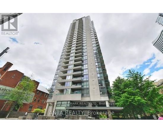 A tall building with the name "Mark Realty" on the front.