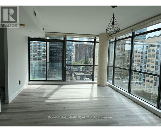 A spacious room with large windows overlooking a cityscape.