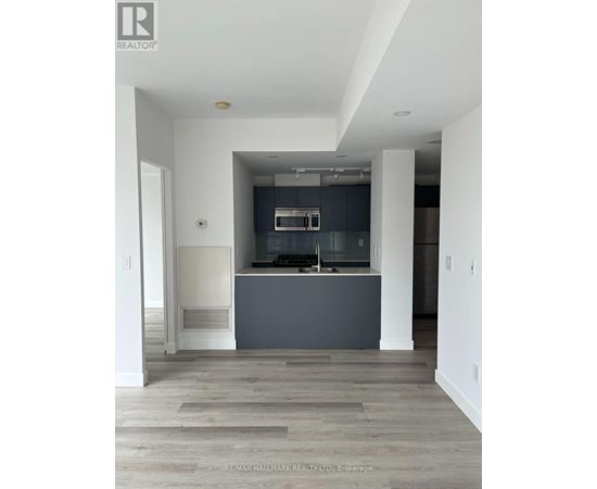 A modern kitchen with a large island and a fireplace.