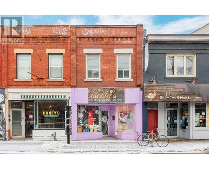 A street view of a row of shops with a bicycle parked in front of them.
