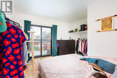 A bedroom with a bed, a wardrobe, and a window with curtains.