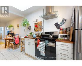 A kitchen with a stove top oven and a refrigerator.