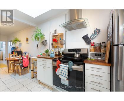 A kitchen with a stove top oven and a refrigerator.
