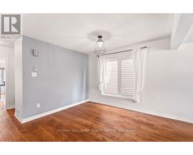A room with wooden floors and white walls.