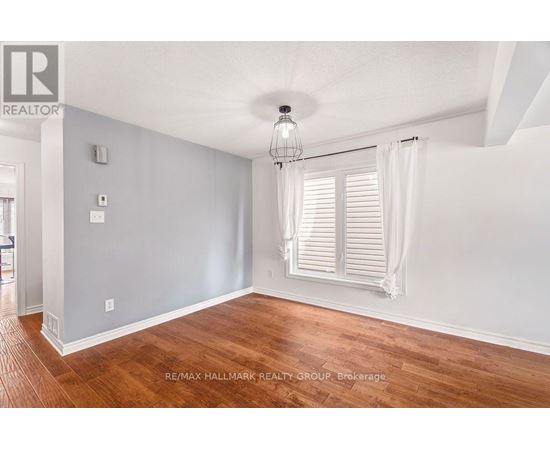 A room with wooden floors and white walls.