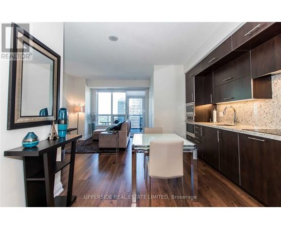 A modern kitchen with dark wood cabinets and a white countertop.
