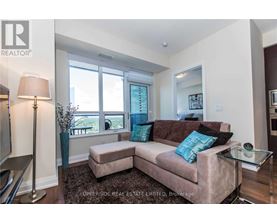 A living room with a couch, a lamp, and a glass table.