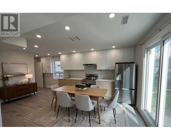 A modern kitchen with a dining table and chairs.
