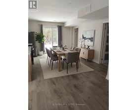 A modern dining room with a wooden table and chairs.