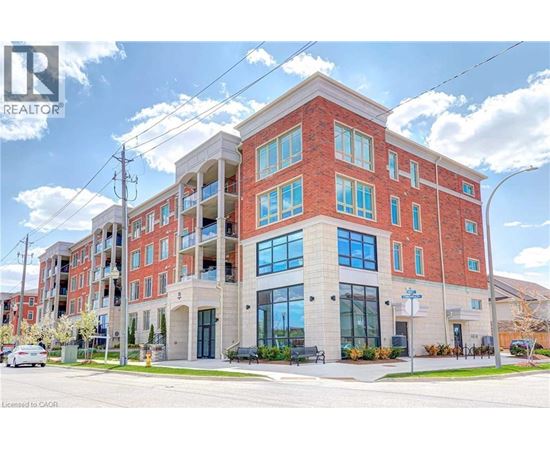 A large red brick building with a glass entrance and a sign that says REALTOR.