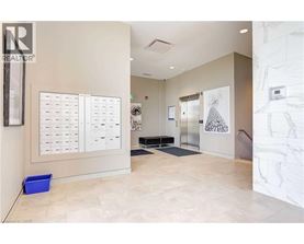 A hallway with a white wall and a calendar on the wall.