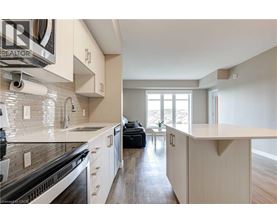 A modern kitchen with white cabinets and a large island.