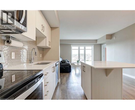 A modern kitchen with white cabinets and a large island.